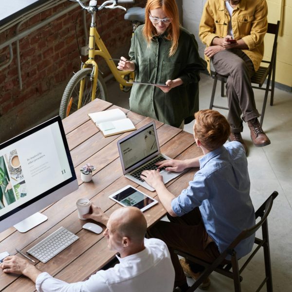 Casual workspace with diverse team working and interacting in a modern office.